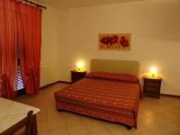 A bed or beds in a room at Le Ginestre Arte Vacanze