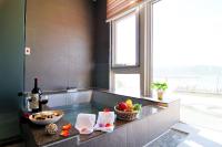 a kitchen with a counter with a bowl of fruit and a window at JinShan Sakura Bay Hot Spring Hotel in Jinshan