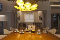 a dining room with a table and a chandelier at ibis Styles Rondonopolis in Rondonópolis