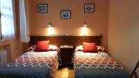 A bed or beds in a room at Hostal San Martin