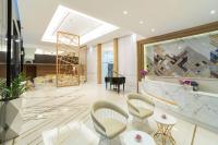 a lobby with a grand piano and chairs at Bandara Suites Silom, Bangkok in Bangkok