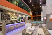 a restaurant with a pool and tables and chairs at Bandara Suites Silom, Bangkok in Bangkok