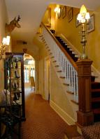 a hallway with a staircase in a house at Foley House Inn in Savannah