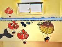 a room with a wall with balloons on the wall at Camellia B&amp;B in Taitung City