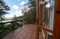 a door to a balcony with a view of a river at Park Hotel Borvikha in Pilichki