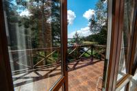an open door to a balcony with a view of a bridge at Park Hotel Borvikha in Pilichki