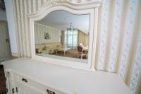 a mirror on a dresser in a living room at Park Hotel Borvikha in Pilichki