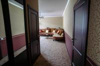 a hallway leading to a living room with a couch at Park Hotel Borvikha in Pilichki