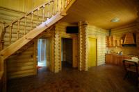 a room with a staircase in a log cabin at Park Hotel Borvikha in Pilichki