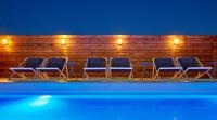 a group of blue chairs sitting next to a wooden fence at Delamar 4*Sup-Adults only (18+) in Lloret de Mar