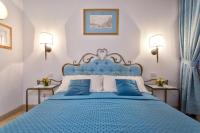 a blue bedroom with a blue bed with blue pillows at Alla Vite Dorata in Venice