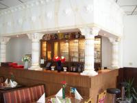 a bar in a restaurant with a lot of wine bottles at Hotel Restaurant Rhodos in Elsterwerda