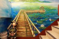 a painting of a person standing on a boardwalk at 5 Loaves 2 Fish B&amp;B in Hualien City