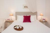 A bed or beds in a room at White Jasmine Cottage
