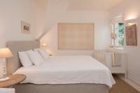 A bed or beds in a room at White Jasmine Cottage