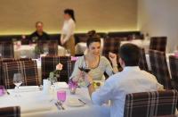 a man and woman sitting at a table with a glass of wine at Bold´S Hotel-Restaurant "Zum Grünen Kranz" in Rodalben