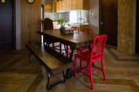 a kitchen with a wooden table and red chairs at Ji Ye Jing Zhan B&amp;B in Ji&#39;an