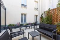 a row of chairs and tables on a balcony at Jardin de Villiers in Paris