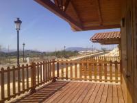a wooden deck with a view of a road at Complejo Pueblo Blanco in Olvera