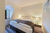 Postel nebo postele na pokoji v ubytování Hotel Vitznauerhof - Lifestyle Hideaway at Lake Lucerne