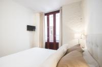 A bed or beds in a room at Valencia Luxury - Boutique Redonda