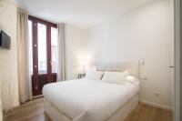 A bed or beds in a room at Valencia Luxury - Boutique Redonda