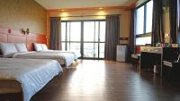 a hotel room with two beds and a large window at Lu Fang View in Donggang