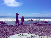 two people standing on a beach looking at the ocean at Bridge12th B&amp;B in Yanliau