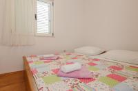 Postel nebo postele na pokoji v ubytování Apartments Rogulj