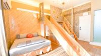 a room with a bed and a staircase at Minsuku B&amp;B in Taitung City