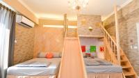 a room with two bunk beds and a staircase at Minsuku B&amp;B in Taitung City
