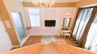 a living room with a chandelier and a rug on the floor at Minsuku B&amp;B in Taitung City