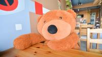 a large brown teddy bear sitting on top of a table at Minsuku B&amp;B in Taitung City