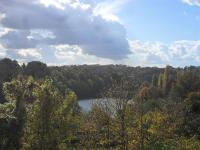 a view of a lake in the middle of a forest at Chambres d&#39;Hôtes Bienvenue in LʼAbsie