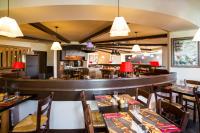 ein Restaurant mit Tischen und Stühlen und eine Bar in der Unterkunft ibis Bordeaux Lac in Bordeaux