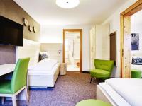 A bed or beds in a room at Das Grüne Hotel zur Post - 100 % BIO