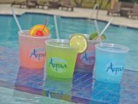 drei Getränke auf einem Tisch neben einem Pool in der Unterkunft Treasure Bay Casino &amp; Hotel-Adults Age 21 and Above in Biloxi