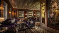 a bar with purple furniture and a wall of windows at Four Seasons Hotel Hong Kong in Hong Kong