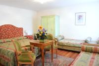 a living room with a couch and a table with flowers on it at Hotel San Zulian in Venice