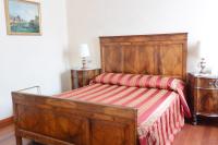 a bedroom with a wooden bed with a striped blanket at Hotel San Zulian in Venice