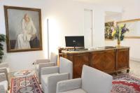 a room with chairs and a picture of a woman at Hotel San Zulian in Venice
