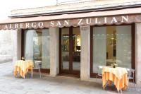 a restaurant with two tables in front of a building at Hotel San Zulian in Venice