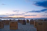 a beach with many beach chairs on the sand at StrandHotel Seeblick, Ostseebad Heikendorf in Heikendorf