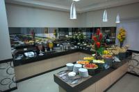 a buffet line in a hotel room with food at Skala Traveling Hotel in Cuiabá
