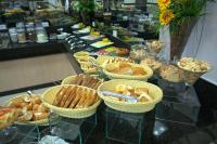 a buffet with baskets of food on a table at Skala Traveling Hotel in Cuiabá