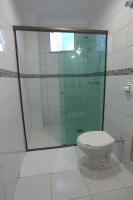 a bathroom with a glass shower and a toilet at Skala Traveling Hotel in Cuiabá
