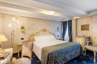 a bedroom with a bed and a table and chairs at Hotel Montecarlo in Venice
