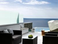 a living room with a view of the ocean at Arpathea Villas in Foiníkion
