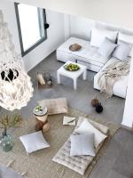 a living room with a white couch and a table at Arpathea Villas in Foiníkion