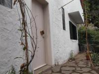 a white house with a door and a walkway at Misurino in Paul